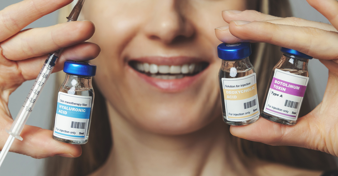 smiling woman with cosmetic injection vials and syringe in hands in Fremont, CA Ariba Medical Spa