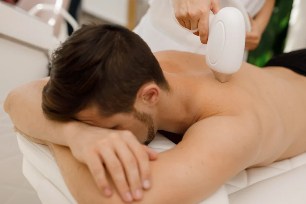 A man lying down on a massage table in Fremont, CA