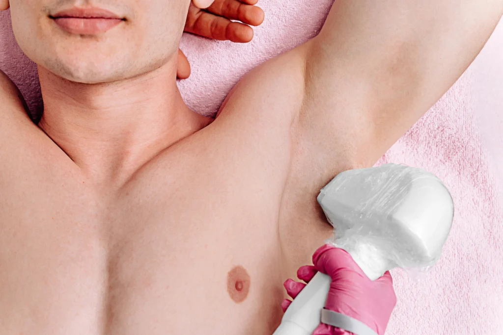 a person's armpit with a pink-gloved hand holding a white object in Fremont, CA