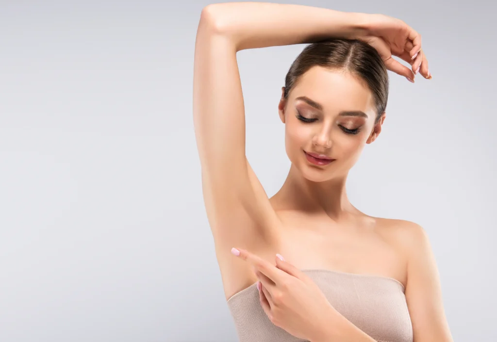 a woman pointing at her armpit in Fremont, CA